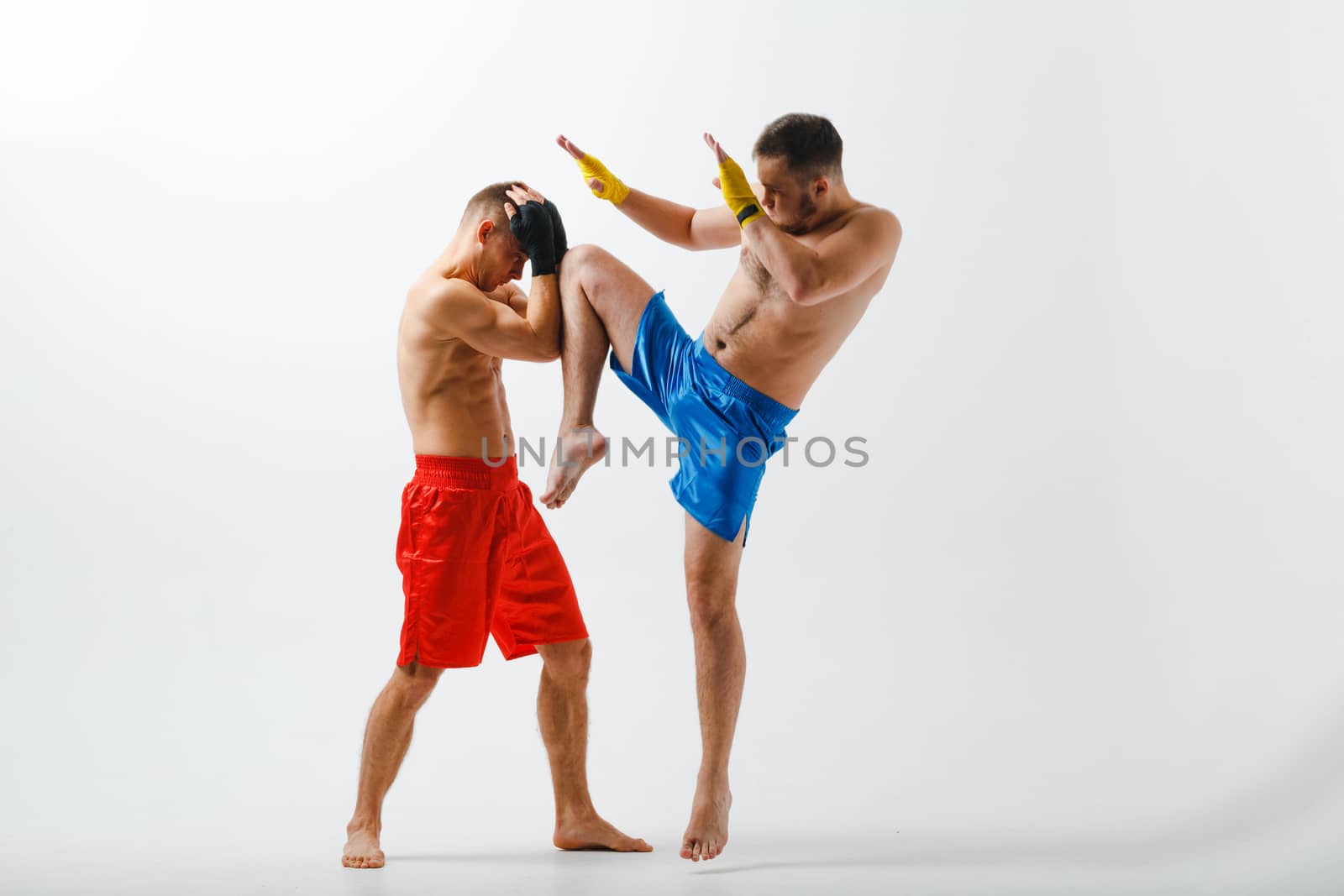 Two men boxers fighting muay thai boxing white background.