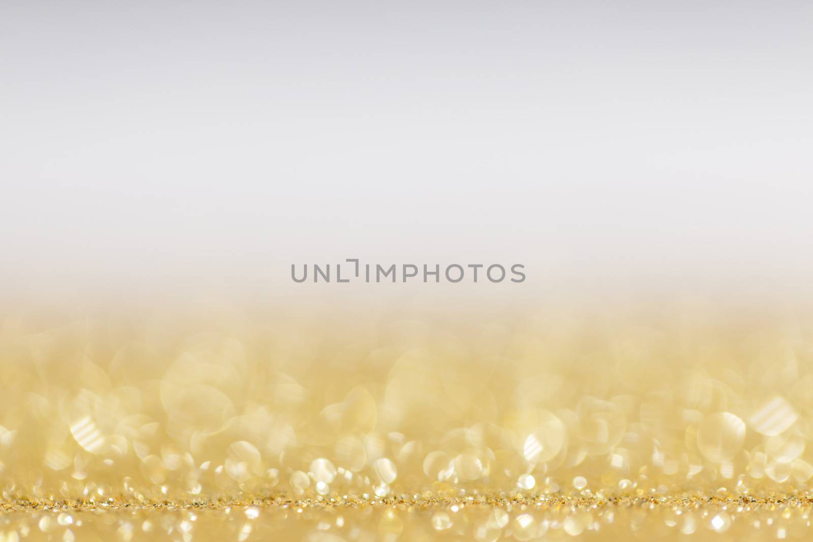 Abstract golden glitter background of shiny lights bokeh Christmas New year celebration luxury party