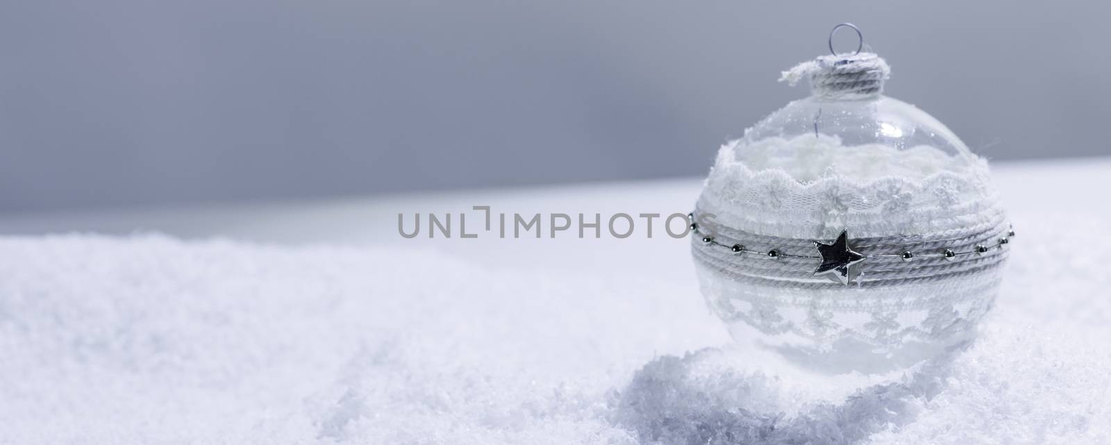 Christmas decorated handmade glass ball in snow brautiful bright background