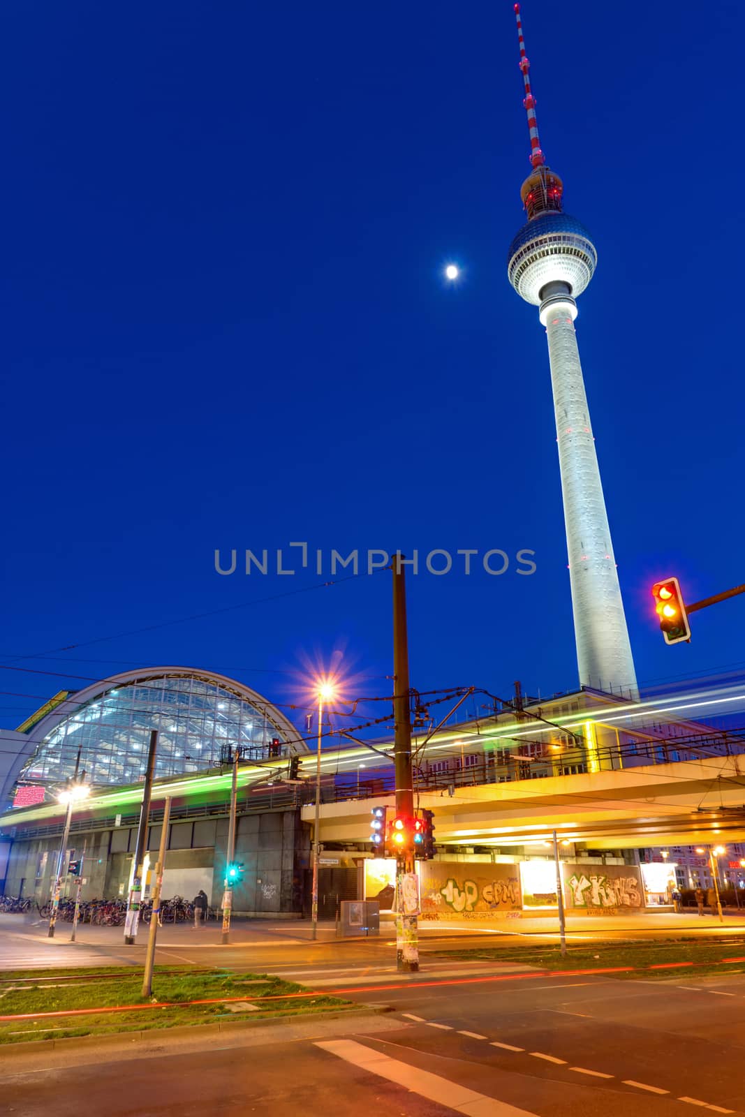 The Alexanderplatz in Berlin at night with the television tower and the train station