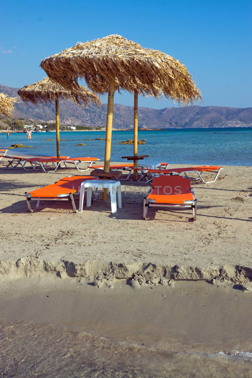 Parasols and sun loungers at a beautiful beach in Greece