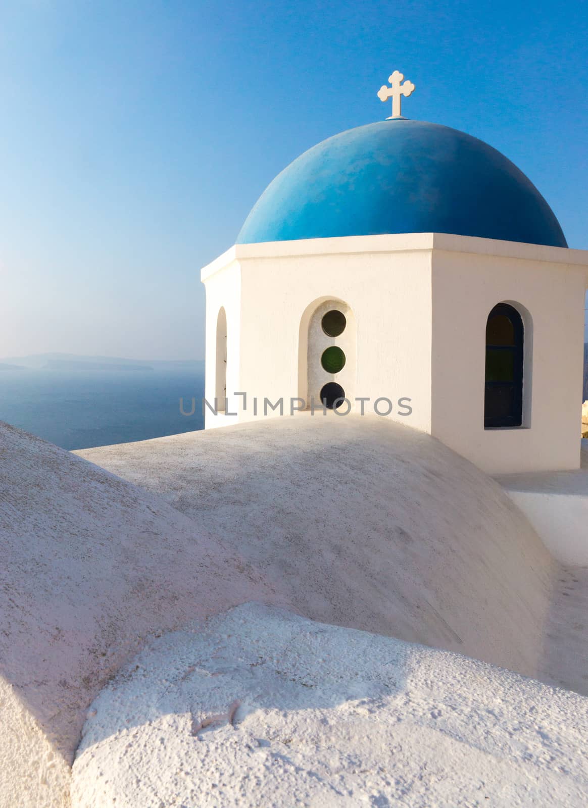 The roof and the blue cupola of a church in Oia, santorini
