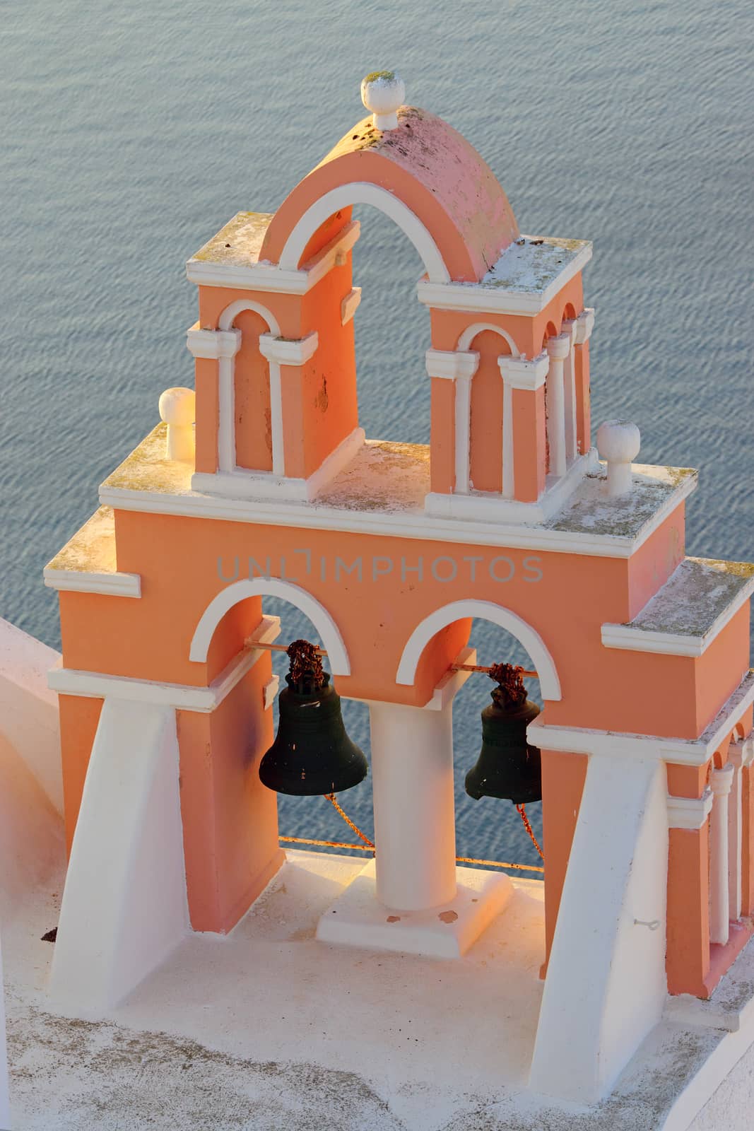 A typical greek belltower high above the sea, seen in Oia, Santorini