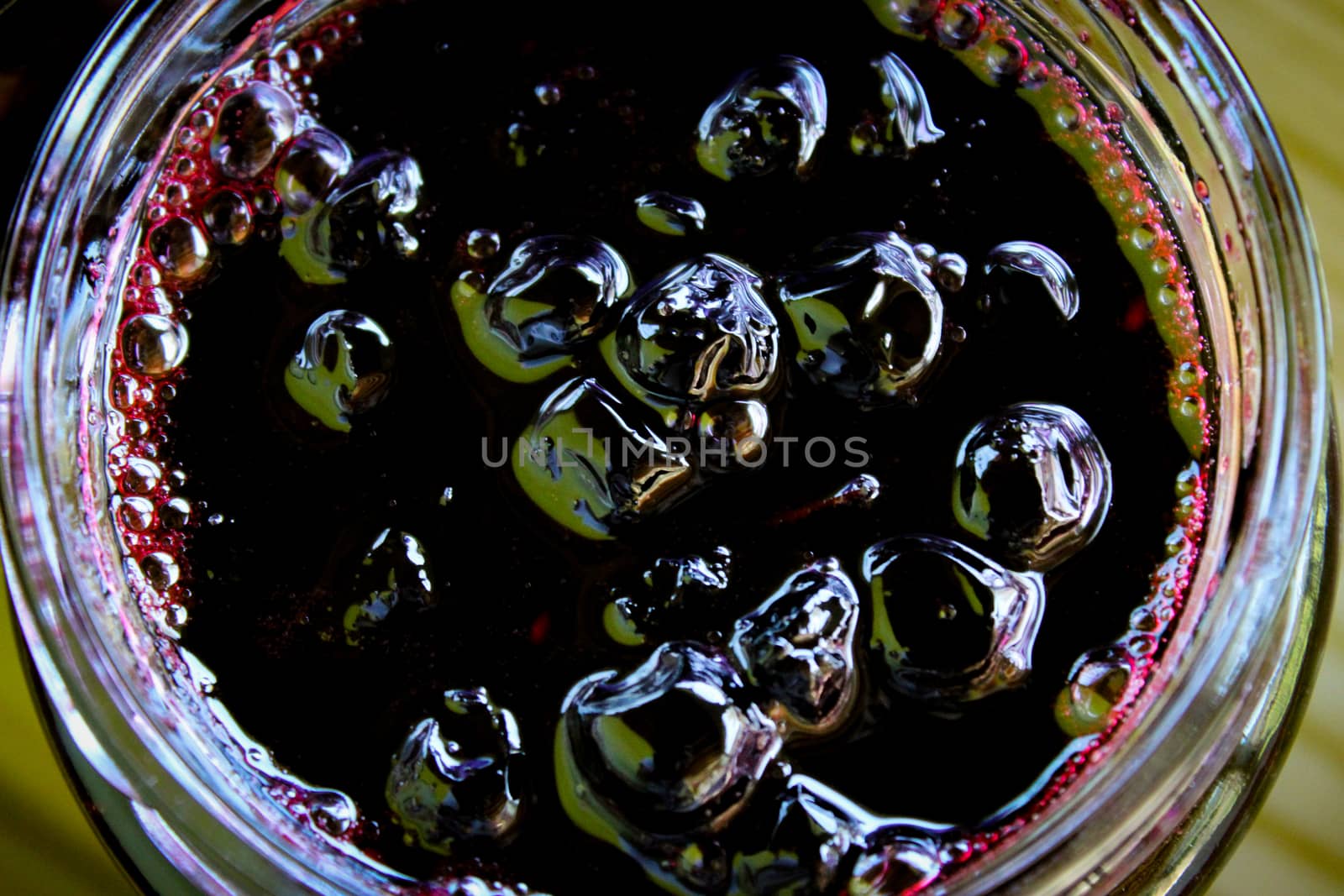 Chokeberry berry jam in a glass jar. Small bubbles around the edges of the jar. Zavidovici, Bosnia and Herzegovina.