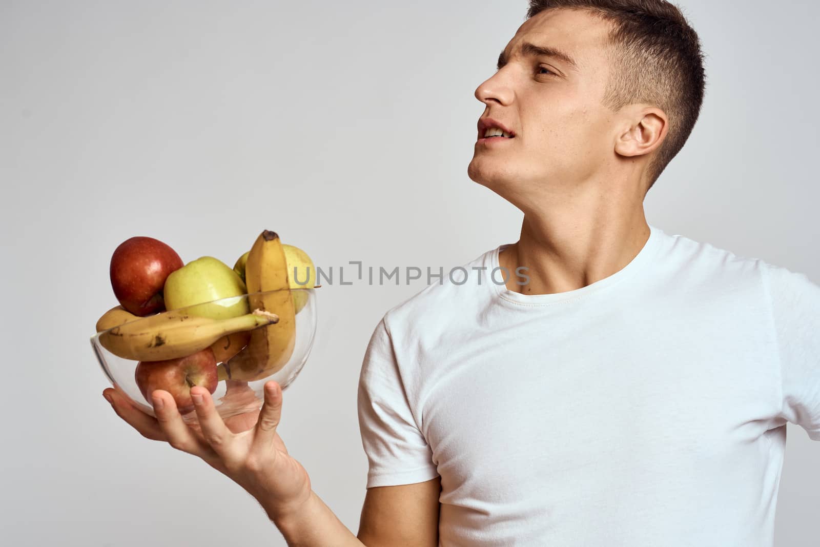 Man with fresh fruit in a cup health lifestyle healthy nutrition vitamins. High quality photo