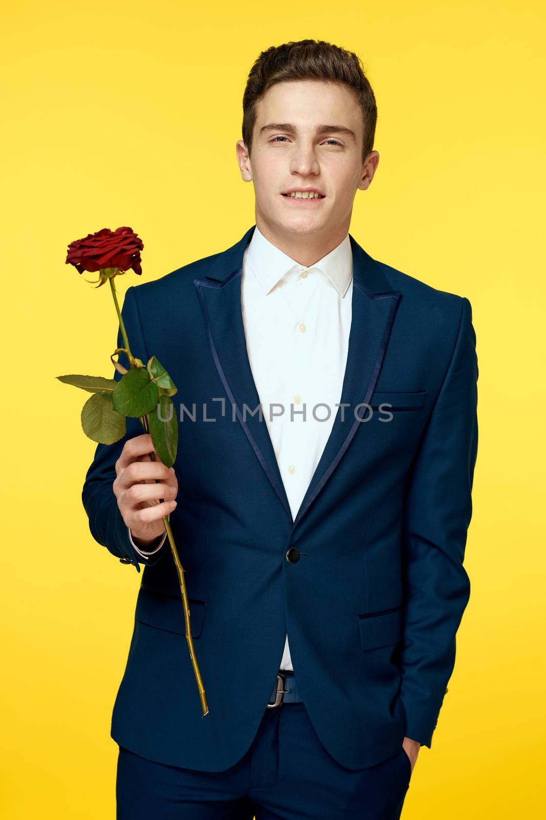 A man in a classic suit with a red rose on a yellow background by SHOTPRIME