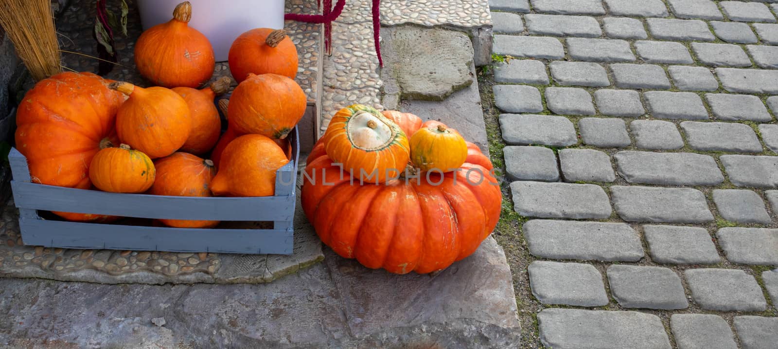 Orange pumpkins of various sizes lie on the porch of the house.The Concept Of Halloween by lapushka62