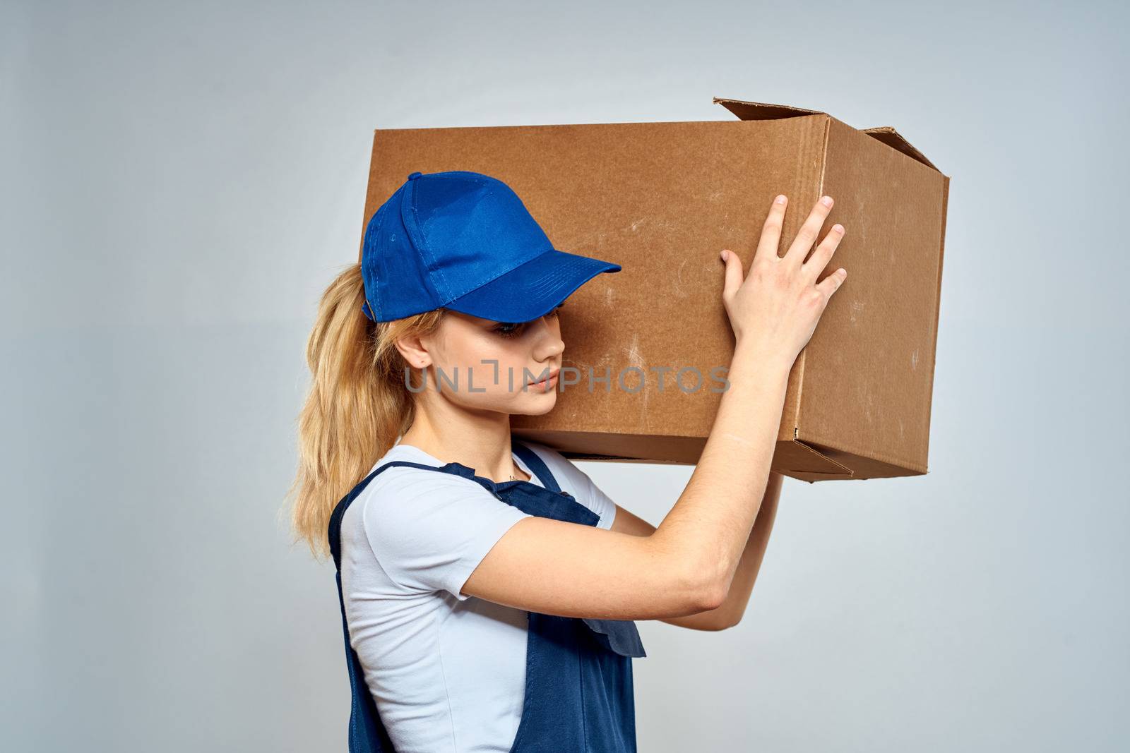 Woman in working uniform box packing service lifestyle by SHOTPRIME