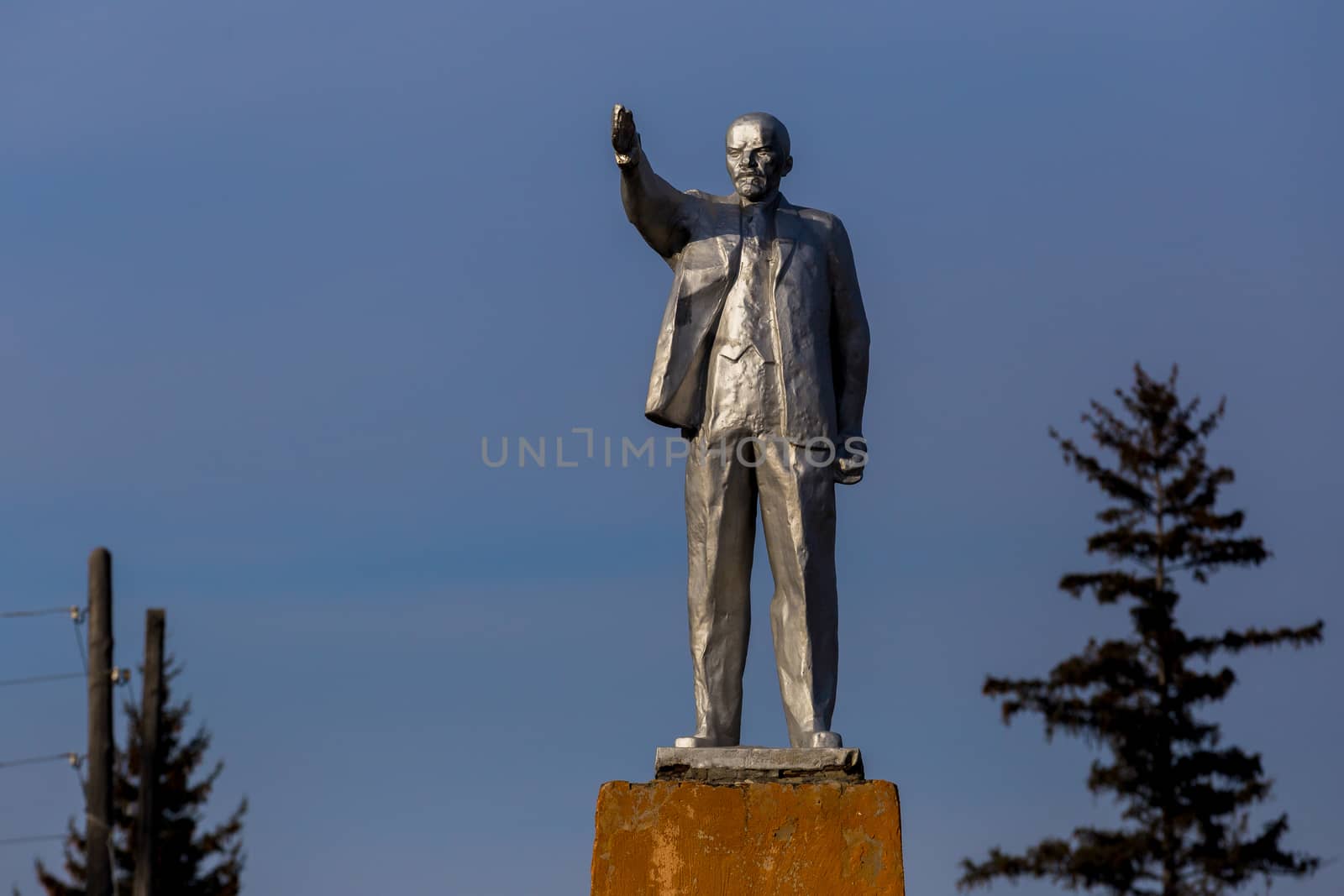 Monument to Vladimir Lenin against the background of blue sky in Russia.