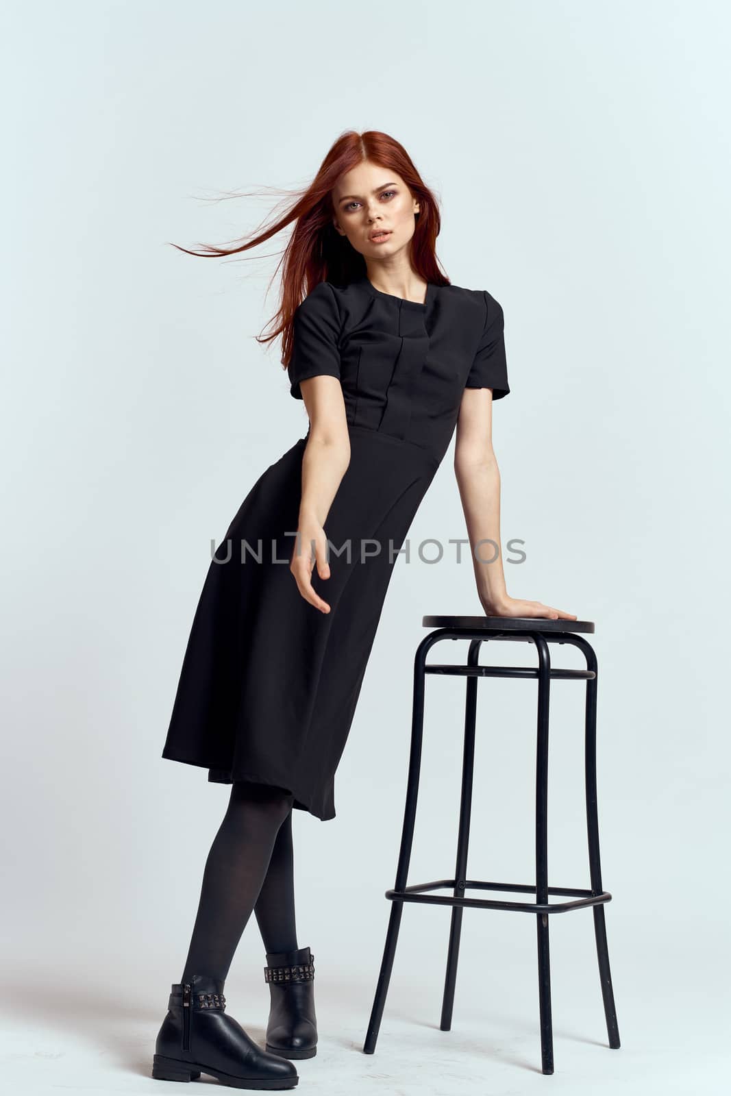 woman high chair indoors full length black dress red hair model boots by SHOTPRIME