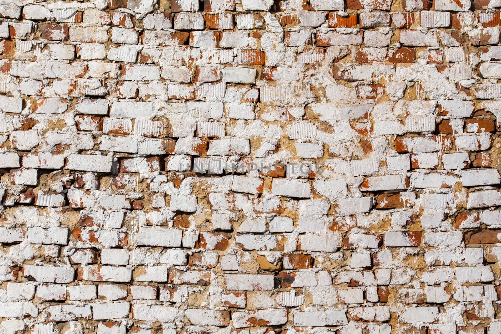 old brick wall with white plaster - full frame background and texture.