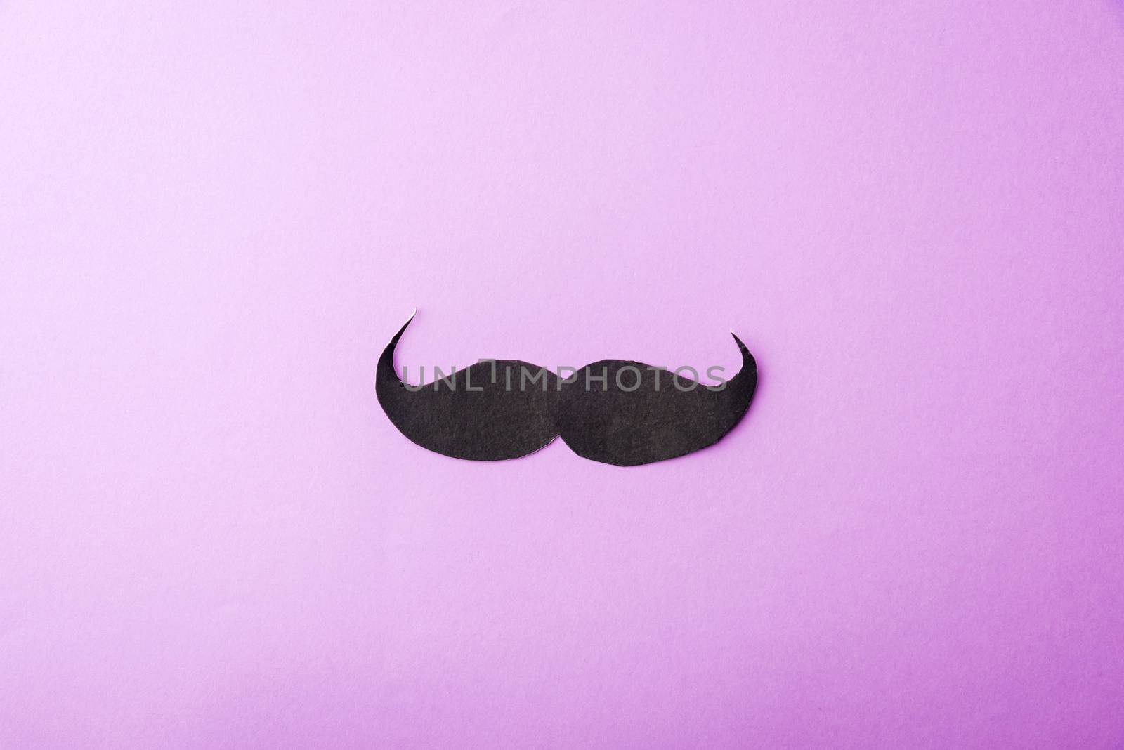 Black mustache paper on purple by Sorapop