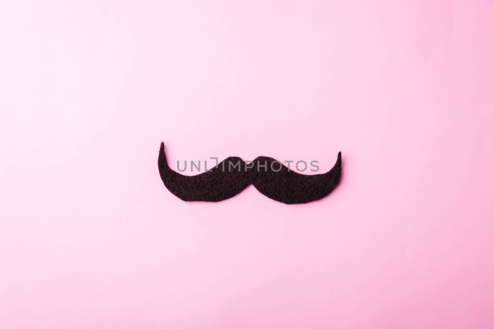 Black mustache paper, studio shot isolated on pink background, Prostate cancer awareness month, Fathers day, minimal November moustache concept