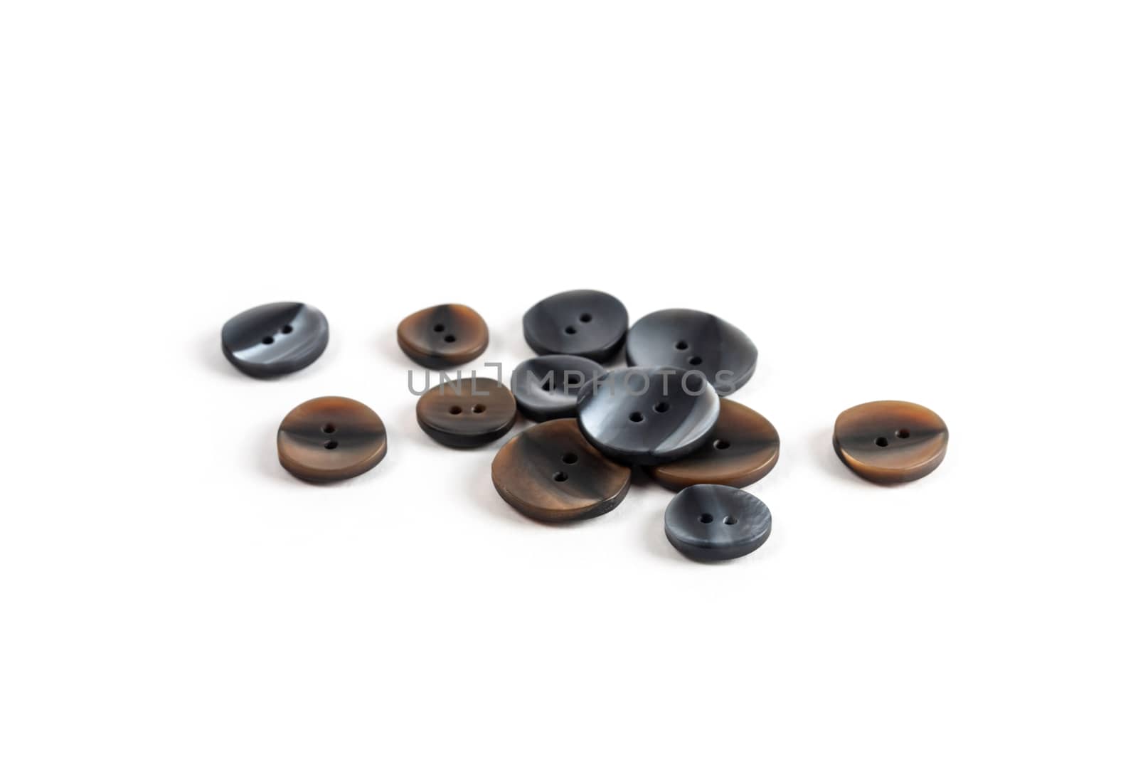 pile, allsorts of brown old gray, beige and brown buttons on a white background. image for sewing and tailor store. space for text