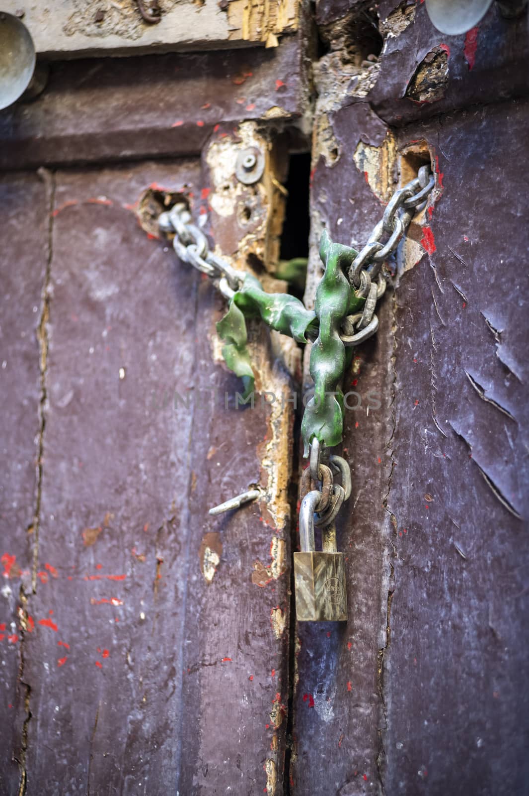 door of an abandoned building with lock and chain