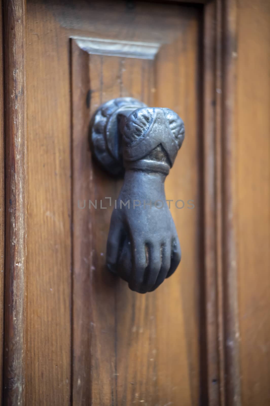 knocker in the shape of a knocking hand in black metal