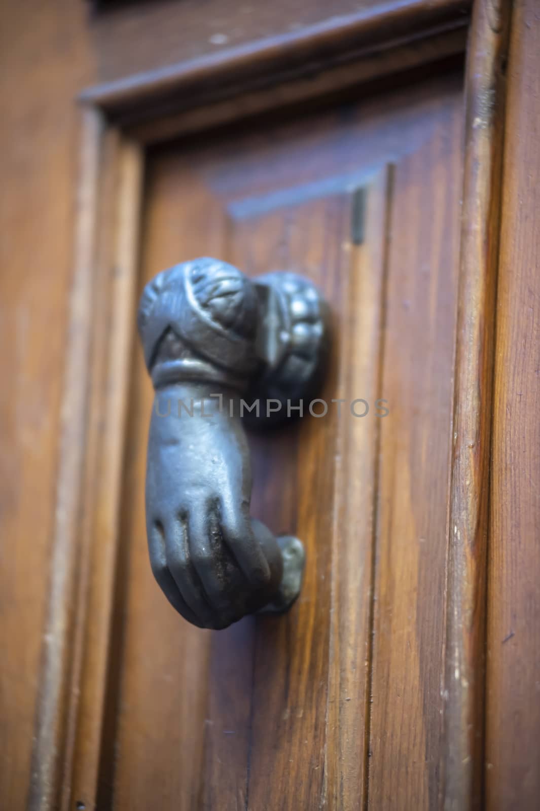 knocker in the shape of a knocking hand in black metal