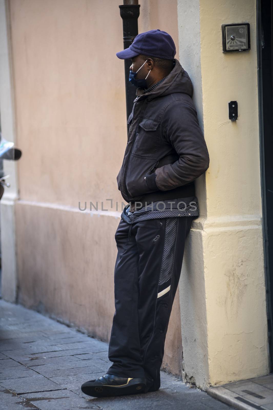 terni,itali october 05 2020:black boy begging outside a shop