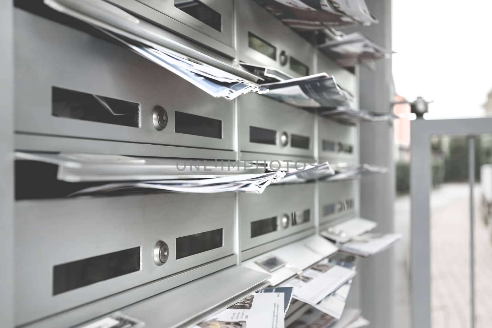 Modern mailboxes filled of flyers. Business and advertising concepts. Shallow depth of field.