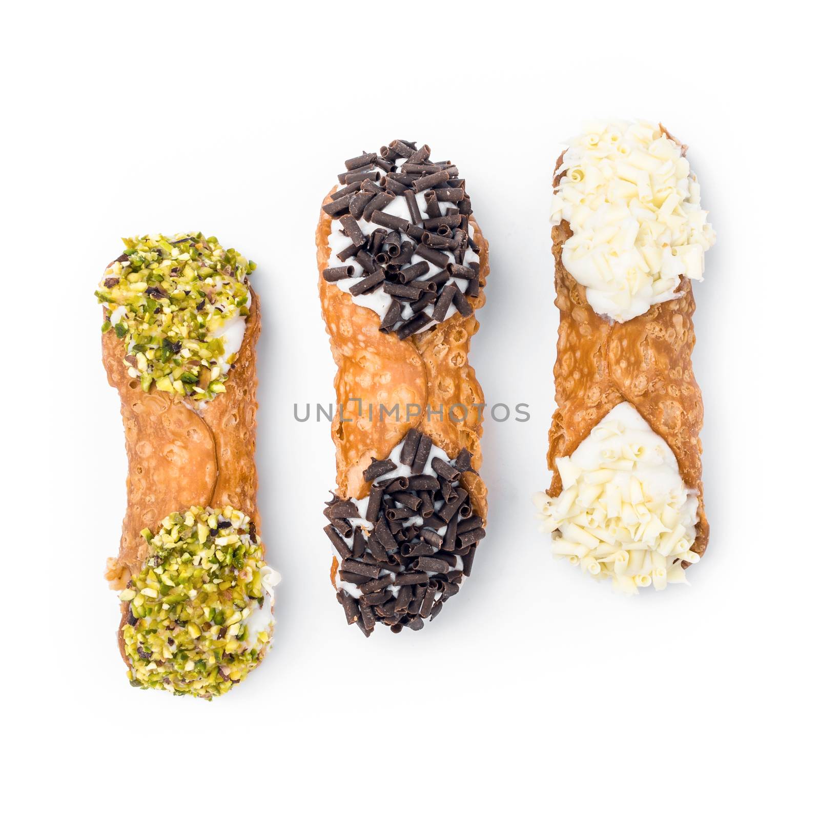 Sicilian cannoli. Three cannoli pastries. Traditional Sicilian dessert, filled with a rich ricotta cream enriched with pistachio grain, hazelnut grain and chocolate flakes.