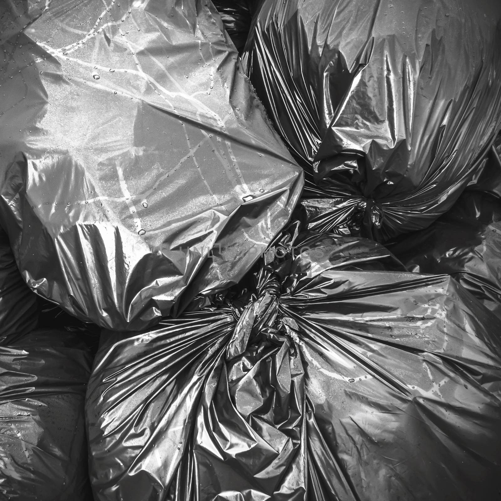 Waste, black garbage bags plastic pile stack. Lots pile of garbage bags stack. Garbage bags background.