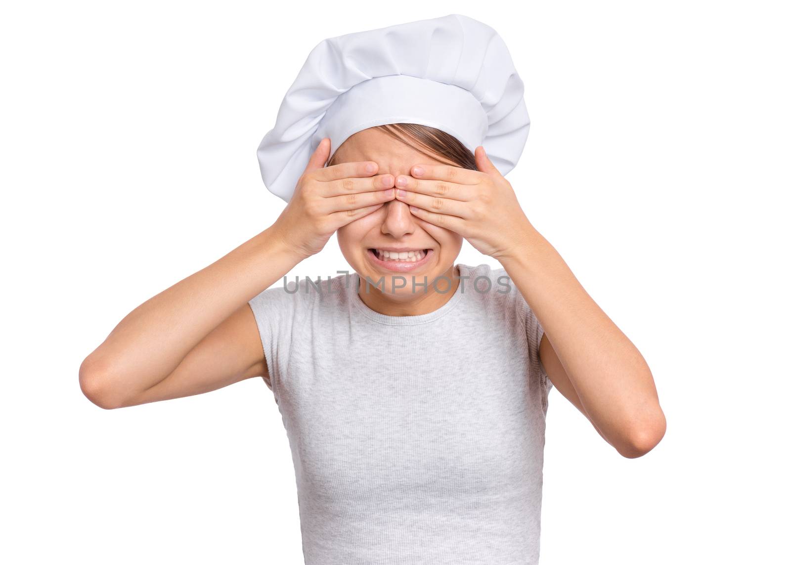 Cute girl in chef hat isolated on white background covering eyes with hands