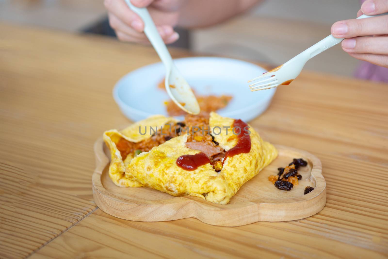 Omelette Wrapped with Pork and Stir-fried Sauce Placed on a wooden plate