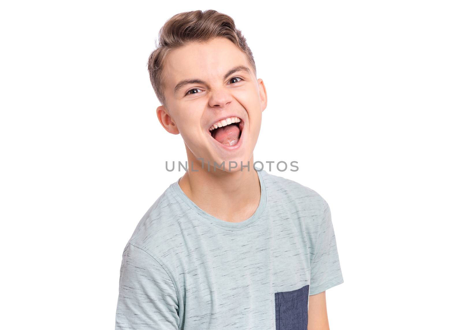Handsome teen boy laughing looking very happy.