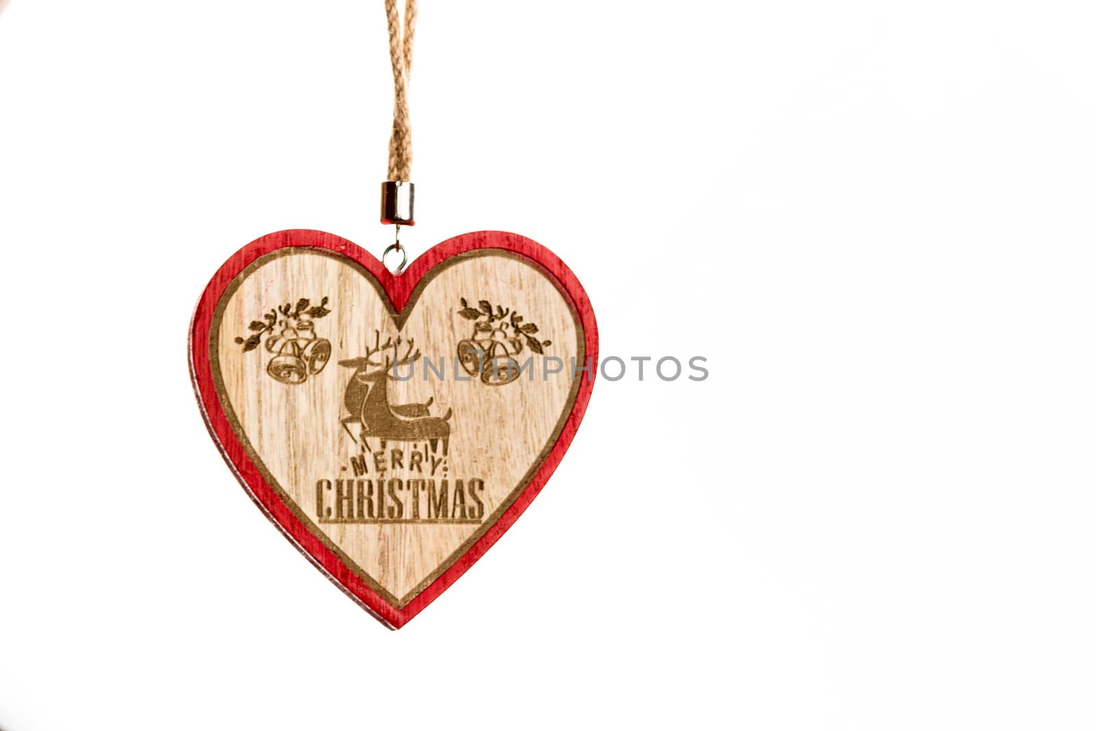 Hand holding heart shaped Christmas decoration isolated on white.