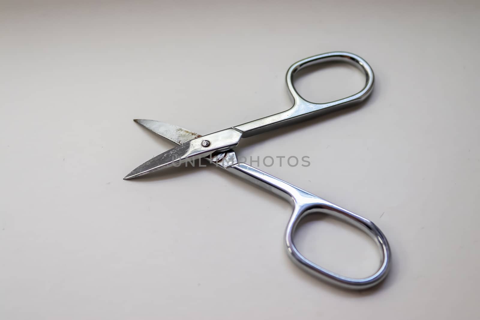 Manicure scissors closeup on white background