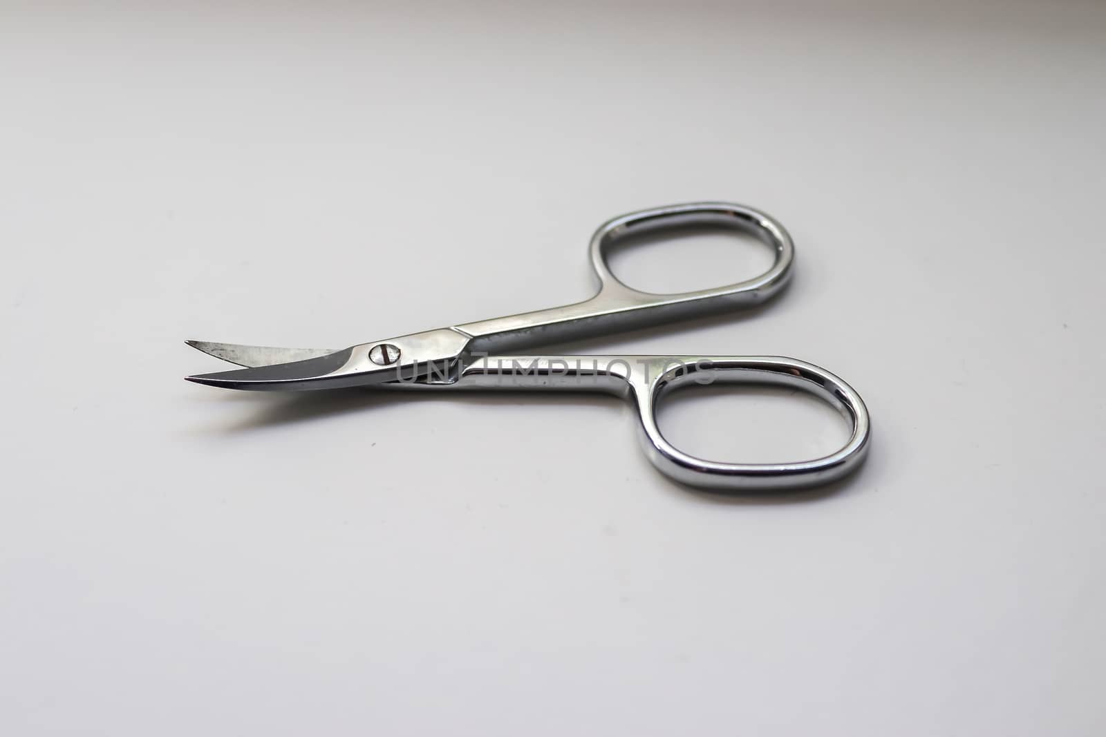 Manicure scissors closeup on white background