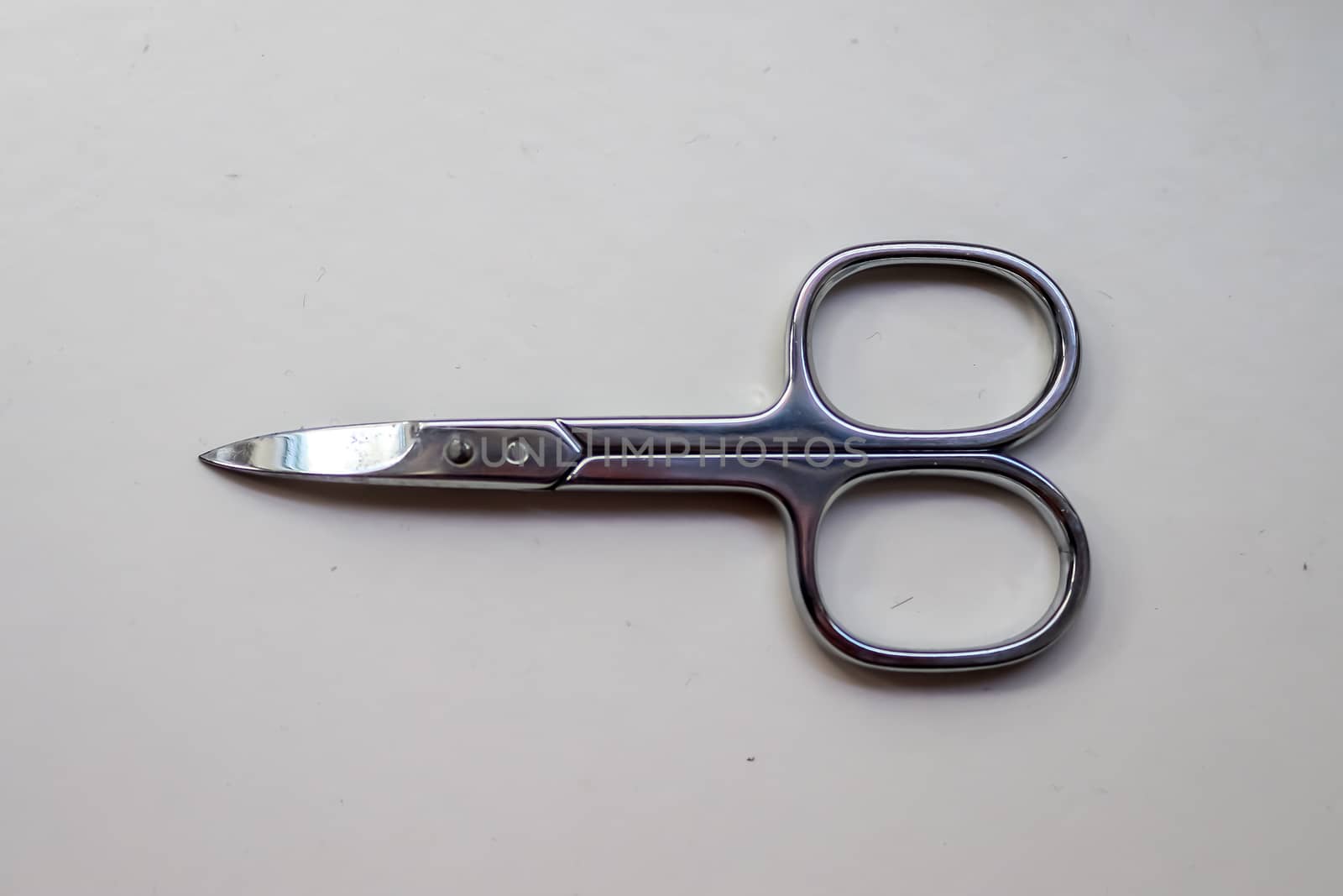 Manicure scissors closeup on white background