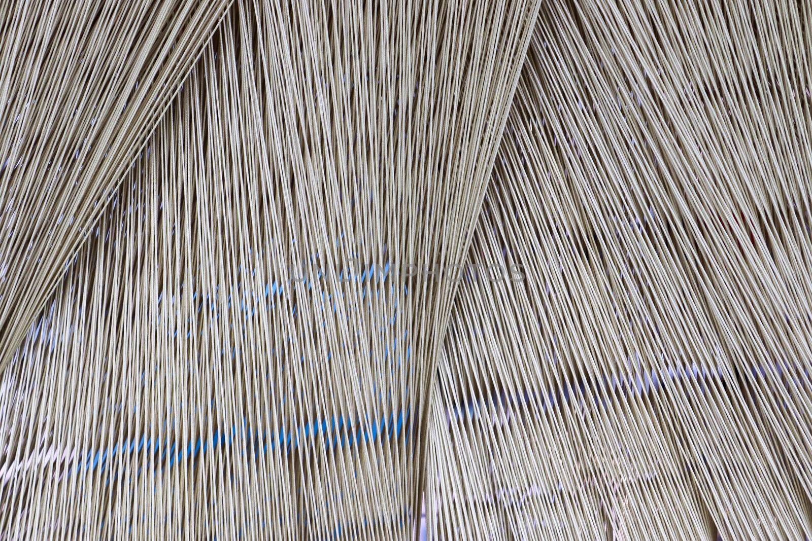 Close up of a lot of threads in a weaving machine called a loom