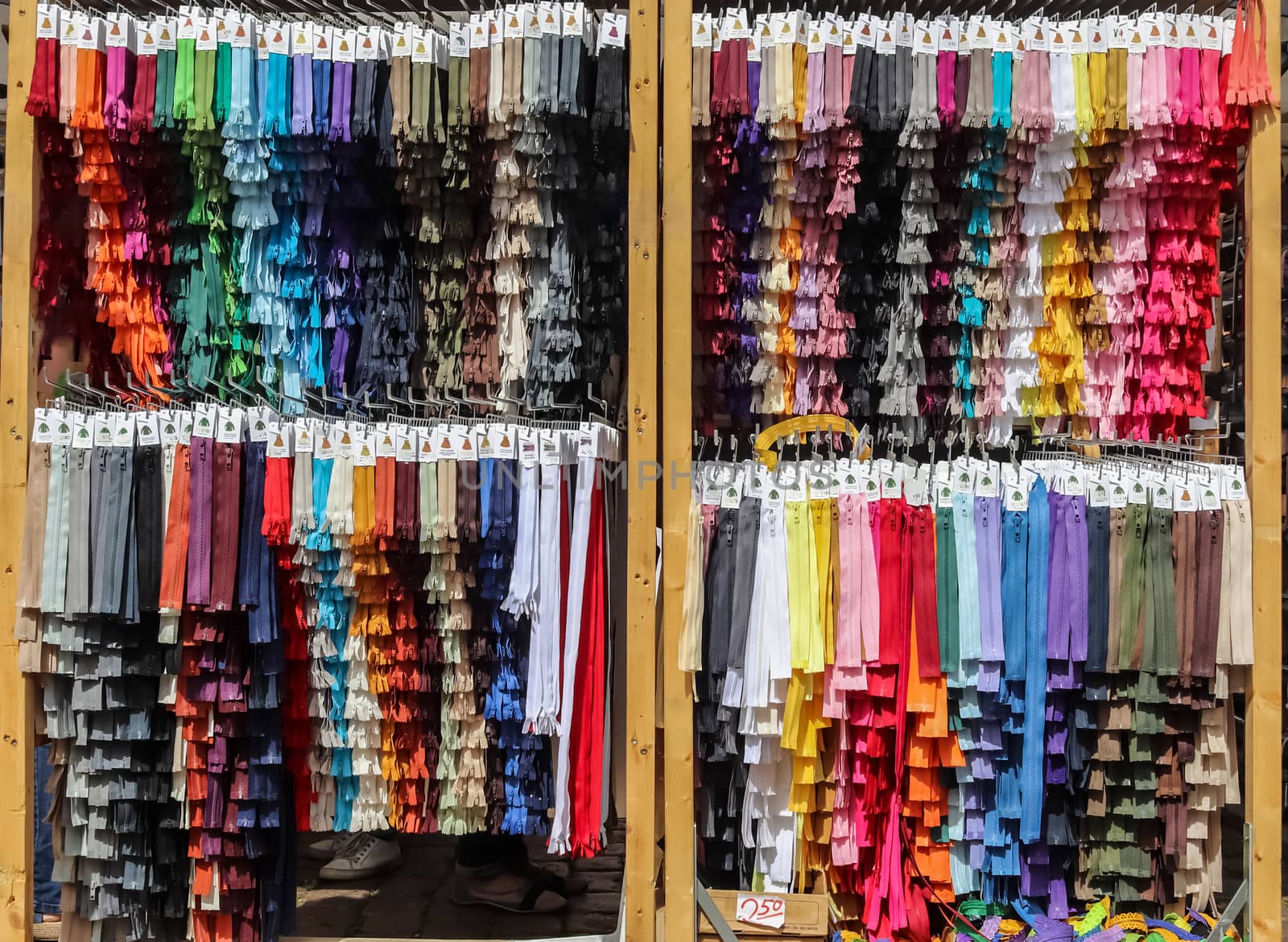 Detailed close up view on samples of zippers in different colors found at a fabrics market.