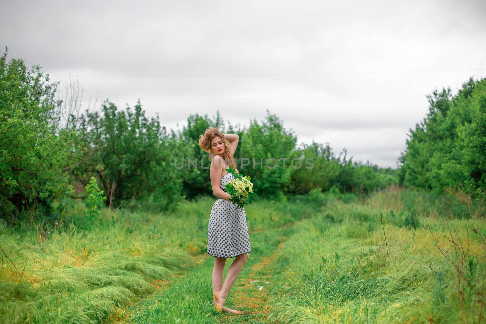 A beautiful young blonde girl collected a bouquet of wildflowers. Enjoy a walk on a warm summer day by Try_my_best