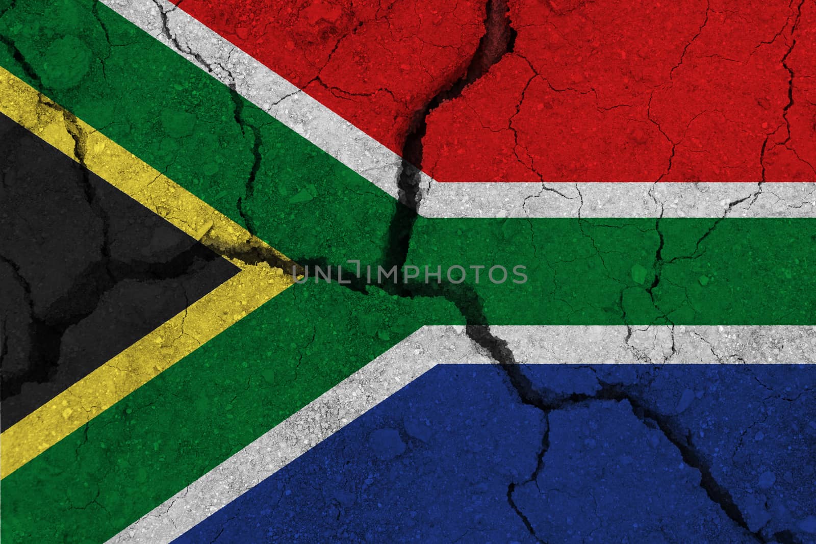 South Africa flag on the cracked earth. National flag of South Africa. Earthquake or drought concept