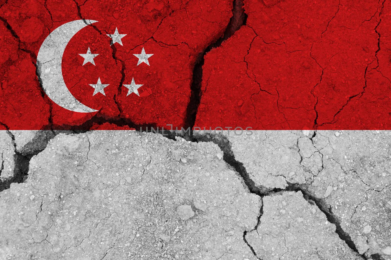 Singapore flag on the cracked earth. National flag of Singapore. Earthquake or drought concept