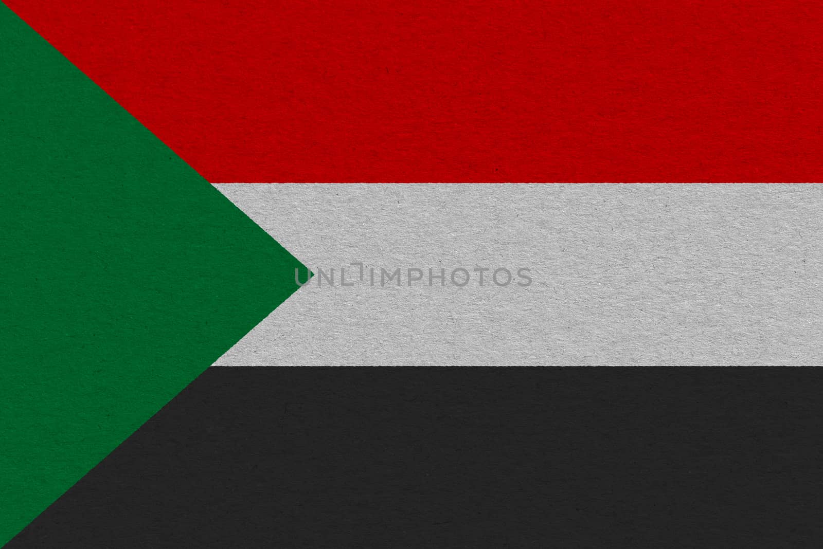 Sudan flag painted on paper. Patriotic background. National flag of Sudan