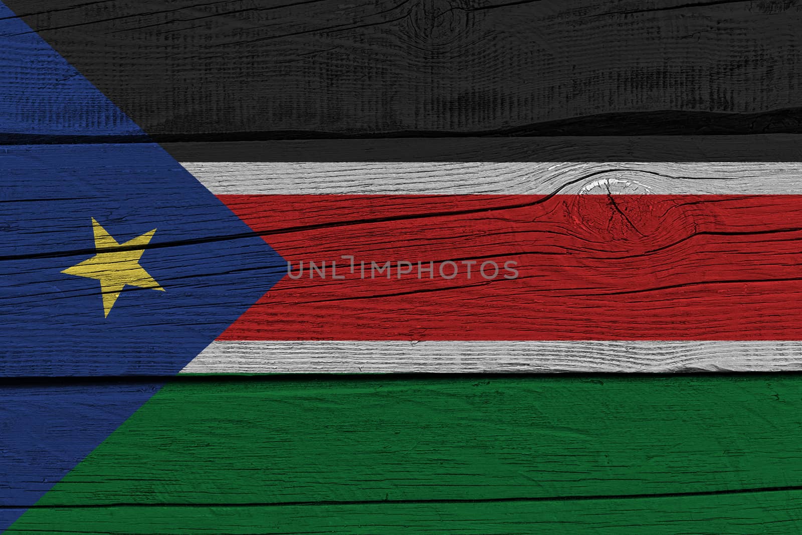 South Sudan flag painted on old wood plank. Patriotic background. National flag of South Sudan