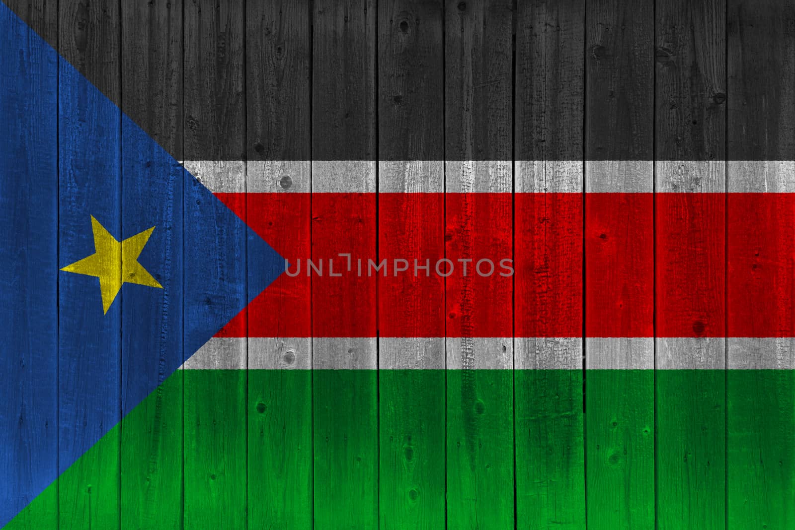 South Sudan flag painted on old wood plank. Patriotic background. National flag of South Sudan