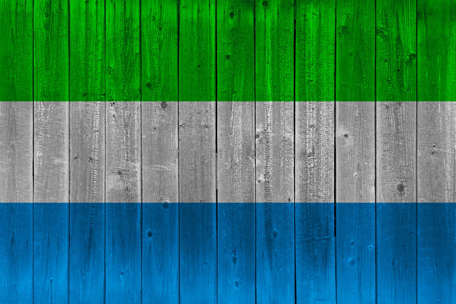 Sierra leone flag painted on old wood plank. Patriotic background. National flag of Sierra leone