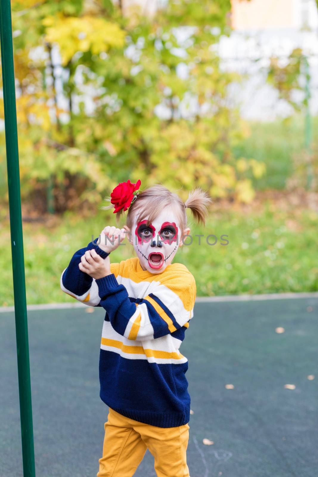 A littlel girl with Painted Face, looking at the camera on Day of the Dead.. by galinasharapova