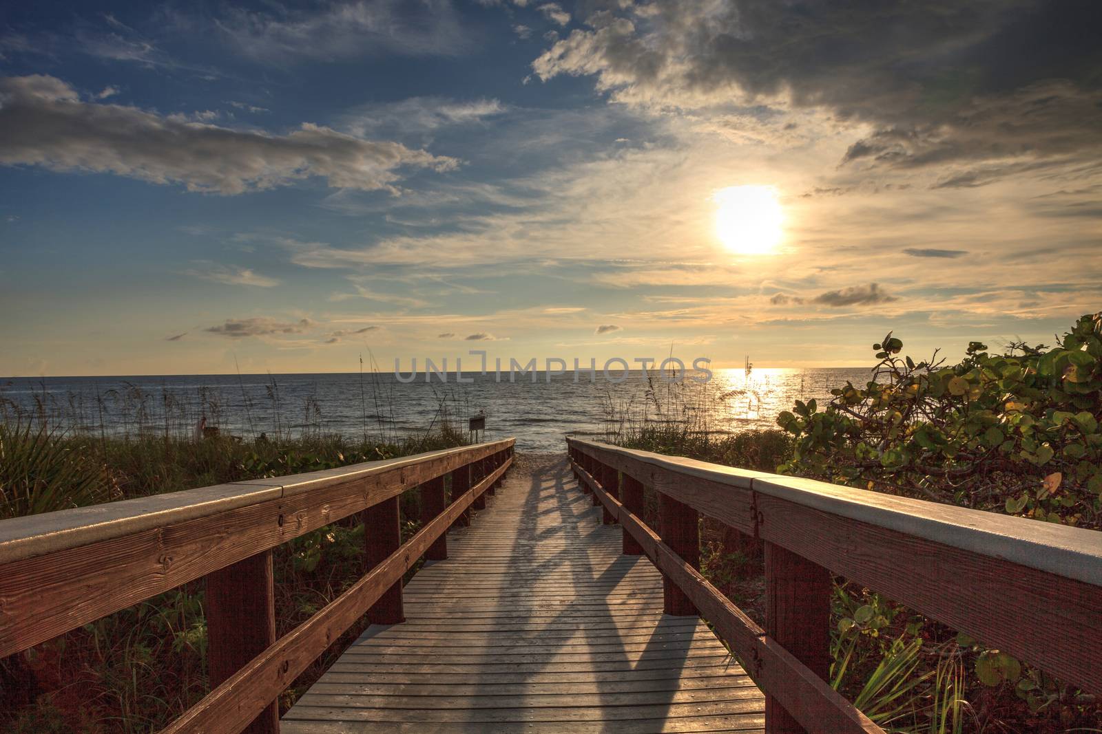 Boardwalk leads down to the white sand of Barefoot Beach in Bonita Springs, Florida