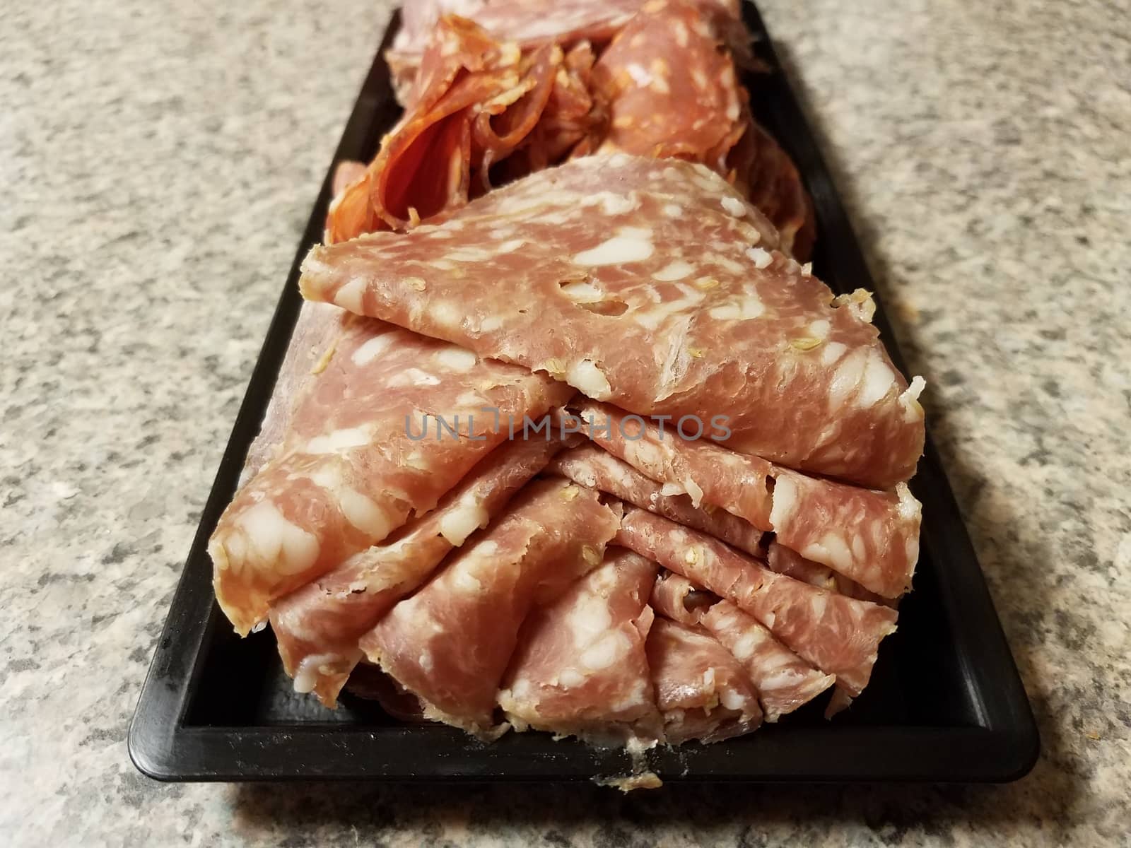 container of sliced salami meat snacks on counter