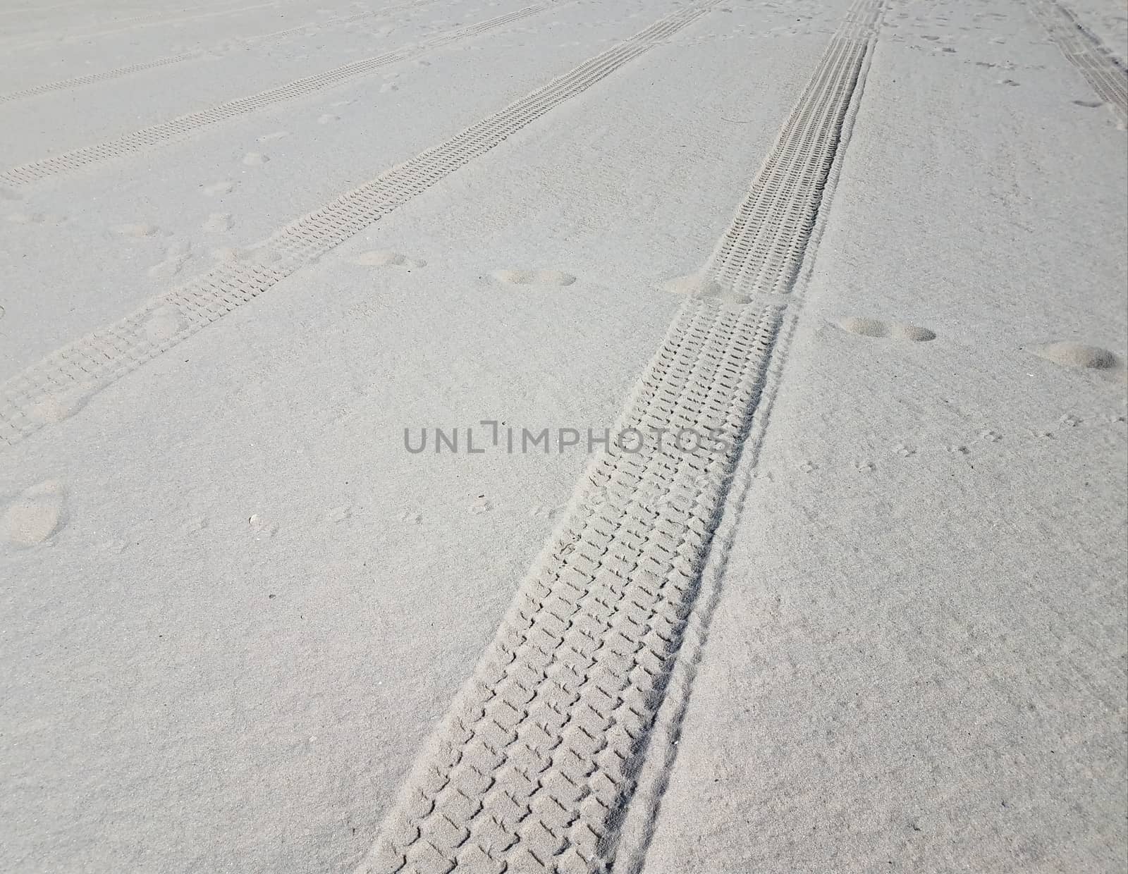 tire tracks and foot prints on combed beach by stockphotofan1