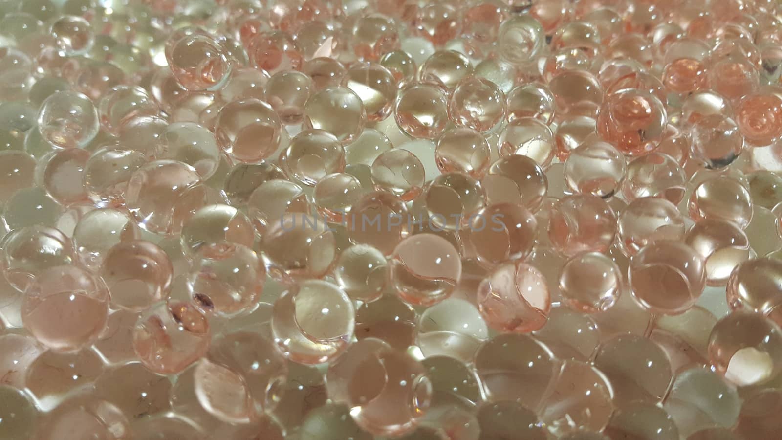 Closeup view with selective focus of shiny glittering orbeez or colorful water balls hydrogel. Water beads orbeez background.