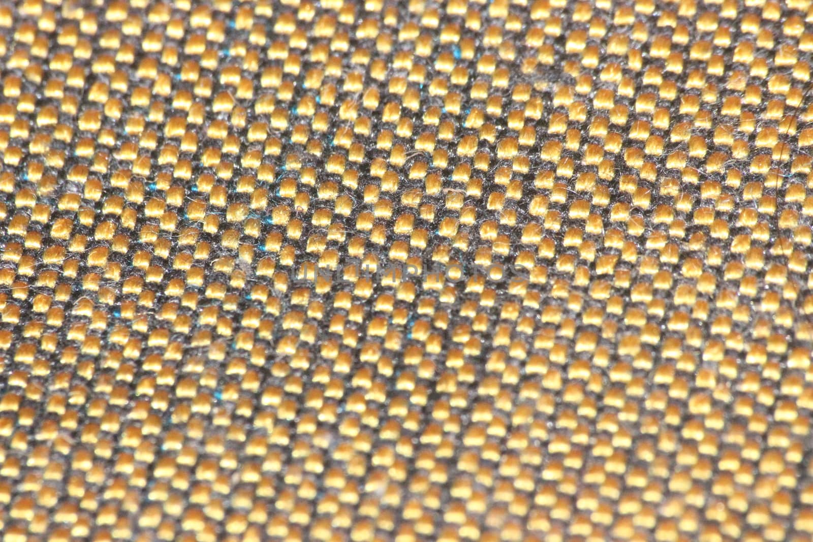macro photo as background close up of golden color cloth fibers knitted and woven