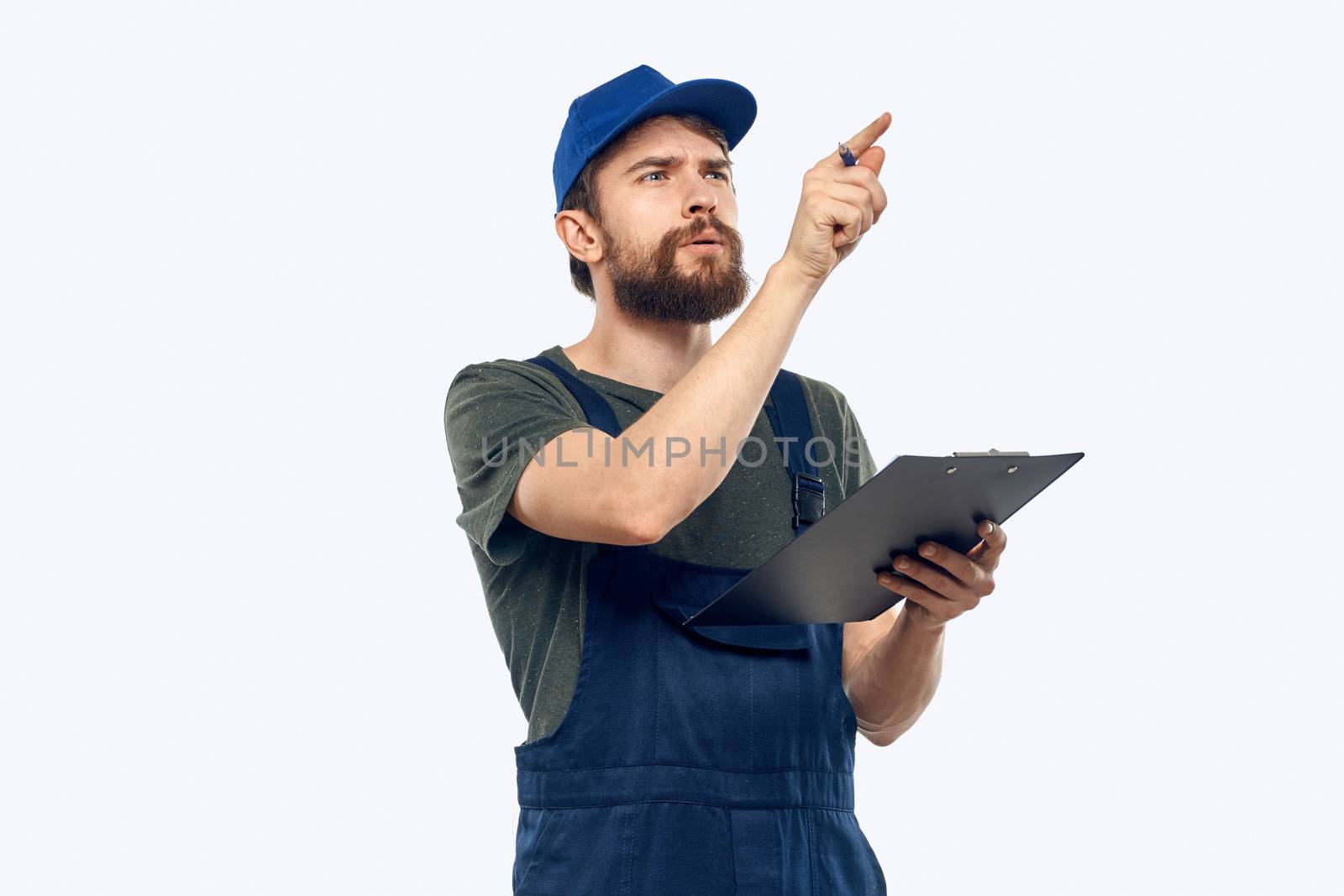 man in working uniform documents delivery loader transportation light background. High quality photo