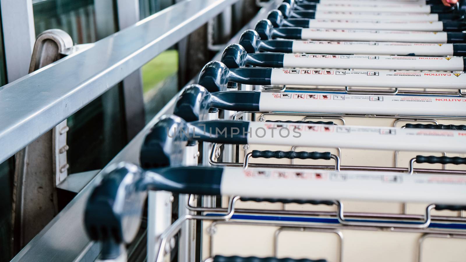 Image of Luggage trolley in a row at the airport