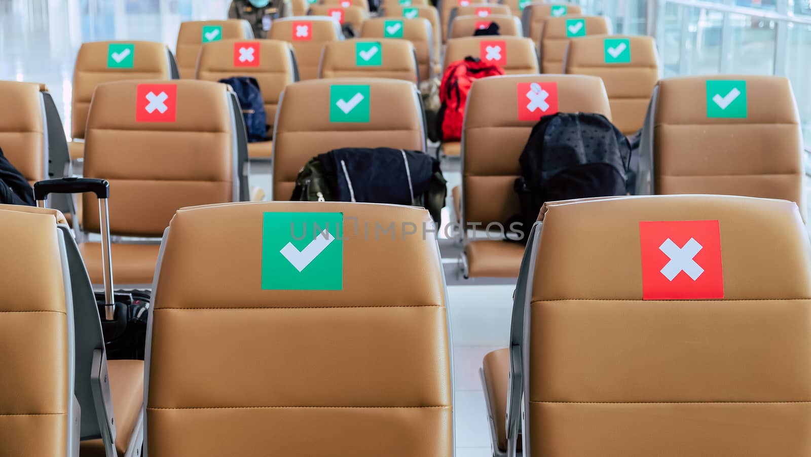 Social distancing, Rows of empty chairs in an airport's departure area marked with symbols regarding social distancing protocol to prevent the spreading of novel corona virus, COVID-19 in Thailand
